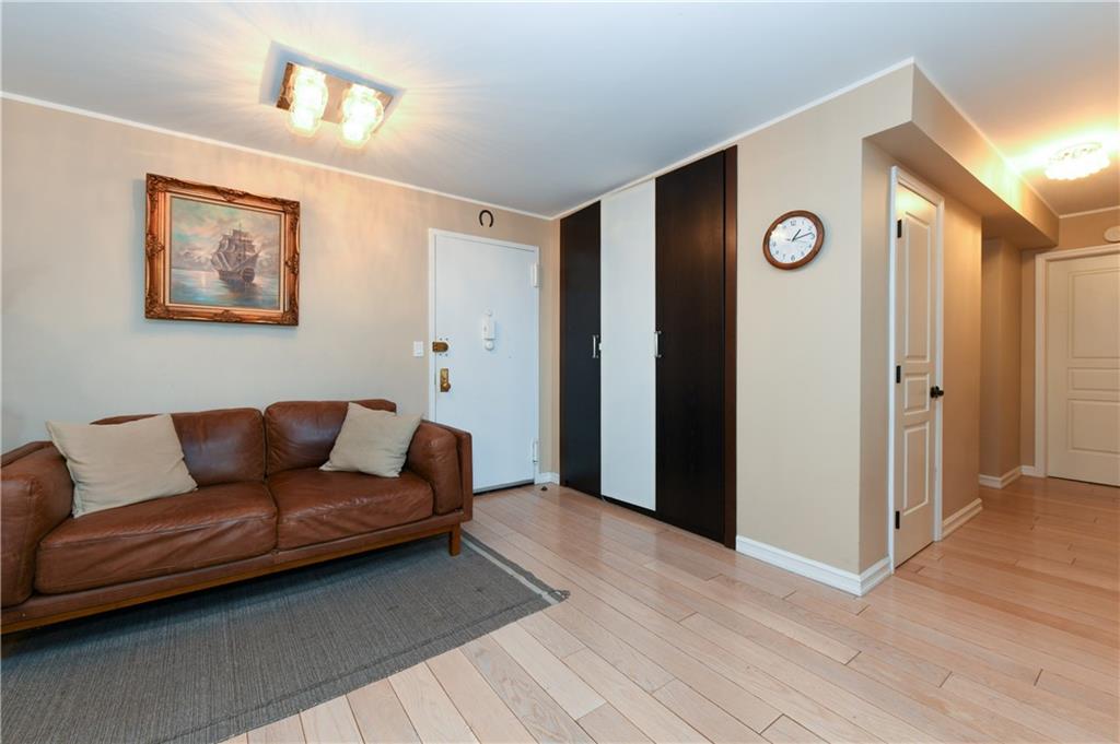 601 Surf Avenue, Unit 20J Brooklyn, NY 11224 - Photo 6 of 46 a blue couch sitting in a living room next to a bathroom