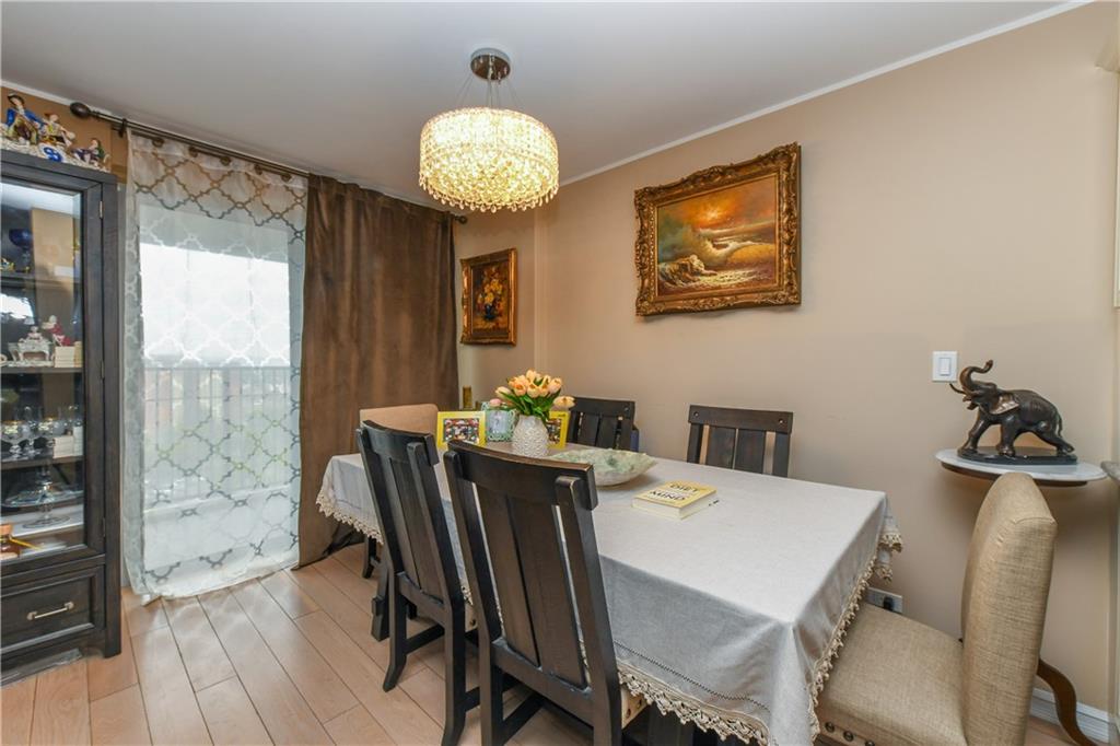 601 Surf Avenue, Unit 20J Brooklyn, NY 11224 - Photo 7 of 46 a view of a dining room with furniture wooden floor and chandelier