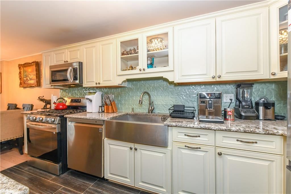601 Surf Avenue, Unit 20J Brooklyn, NY 11224 - Photo 9 of 46 a kitchen with stainless steel appliances granite countertop a sink and cabinets
