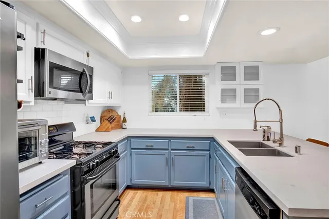 a kitchen with a sink stove top oven and microwave