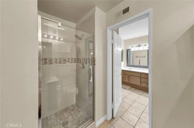 a bathroom with a glass shower door