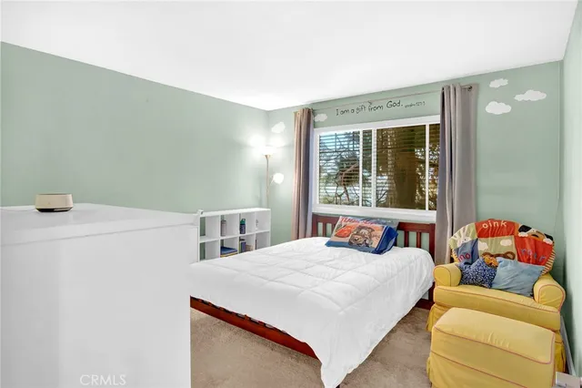 a bedroom with a bed and a window