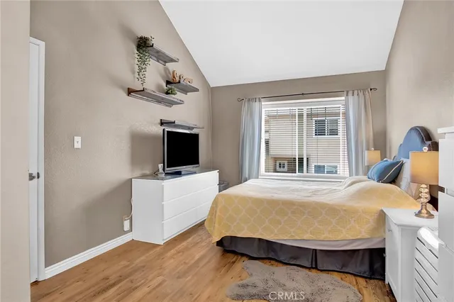 a bedroom with a bed and flat tv screen