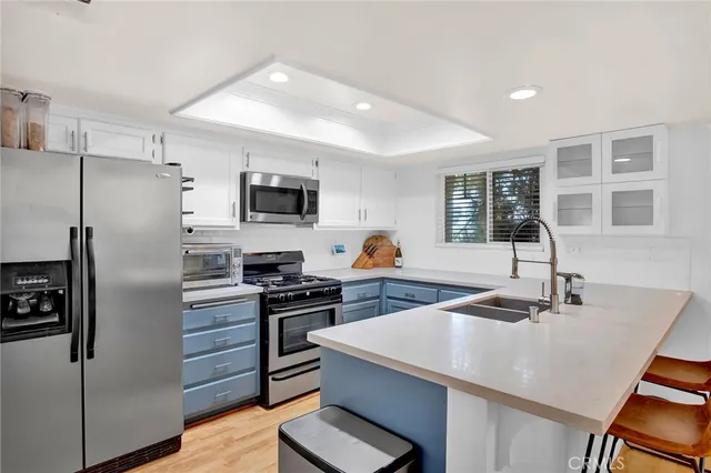 a kitchen with a refrigerator a sink and a stove
