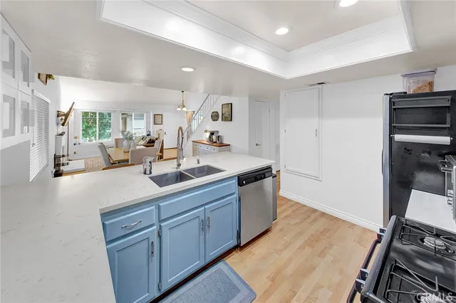a kitchen with sink stove and refrigerator