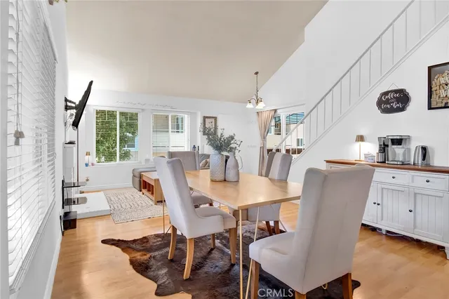 a view of a dining room with furniture and a large window