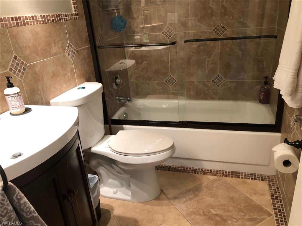 252 Pebble Beach Circle, Unit C103 Naples, FL 34113 - Photo 13 of 21 a bathroom with a toilet and a shower