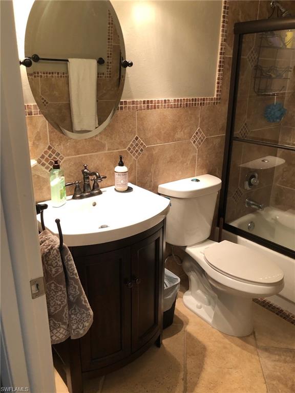 252 Pebble Beach Circle, Unit C103 Naples, FL 34113 - Photo 14 of 21 a bathroom with a sink toilet and a mirror