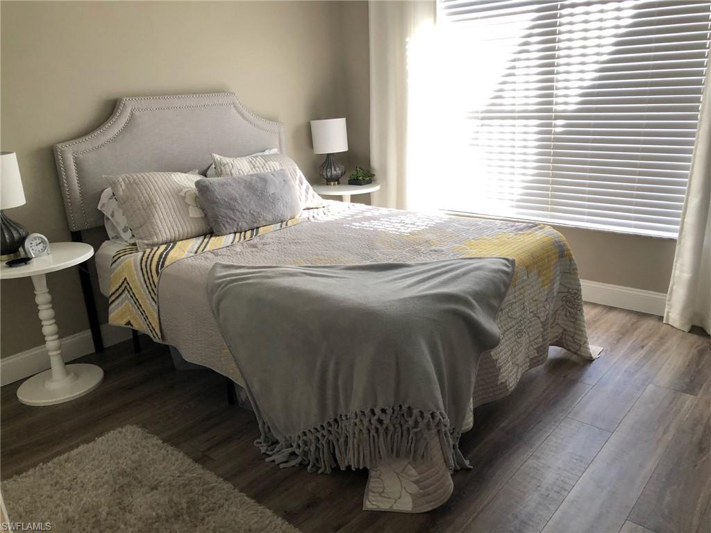 252 Pebble Beach Circle, Unit C103 Naples, FL 34113 - Photo 15 of 21 a bedroom with a bed and a window