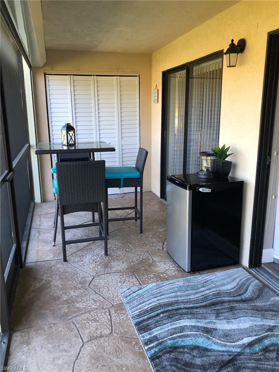 252 Pebble Beach Circle, Unit C103 Naples, FL 34113 - Photo 17 of 21 a view of a workspace with furniture and a window