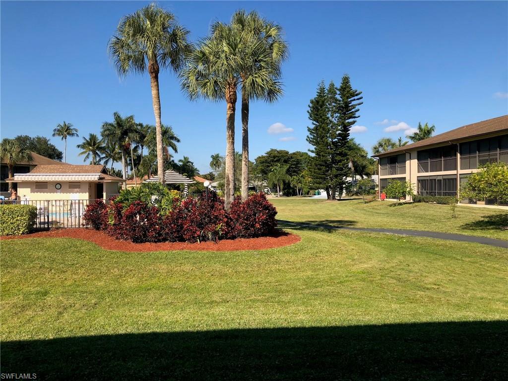 252 Pebble Beach Circle, Unit C103 Naples, FL 34113 - Photo 18 of 21 a view of a house with yard and swimming pool