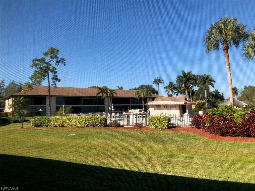 252 Pebble Beach Circle, Unit C103 Naples, FL 34113 - Photo 19 of 21 a front view of a house with garden