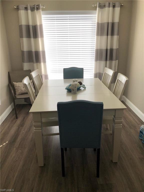 252 Pebble Beach Circle, Unit C103 Naples, FL 34113 - Photo 21 of 21 a view of a dining room with furniture and wooden floor