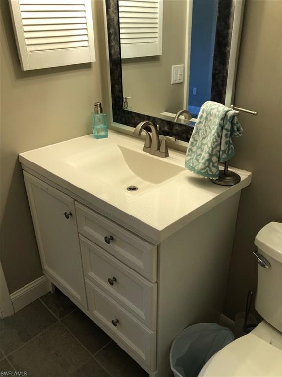 252 Pebble Beach Circle, Unit C103 Naples, FL 34113 - Photo 10 of 21 a bathroom with a sink and a toilet