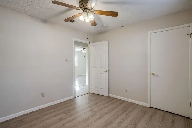 a view of an empty room and wooden floor