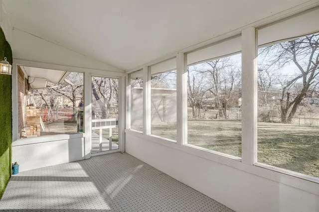 a view of entrance with wooden floor and door
