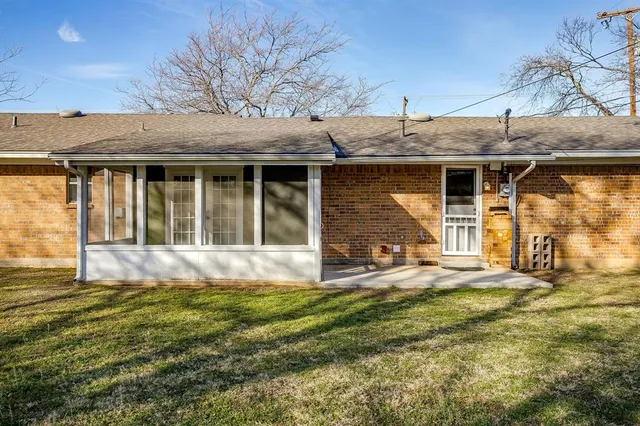 a view of backyard with wooden fence