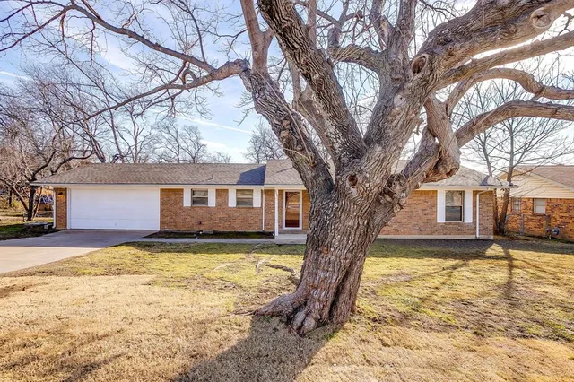 a large tree in front of a house