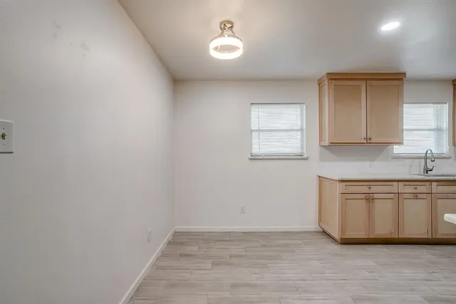 a view of a kitchen with sink cabinets and a window