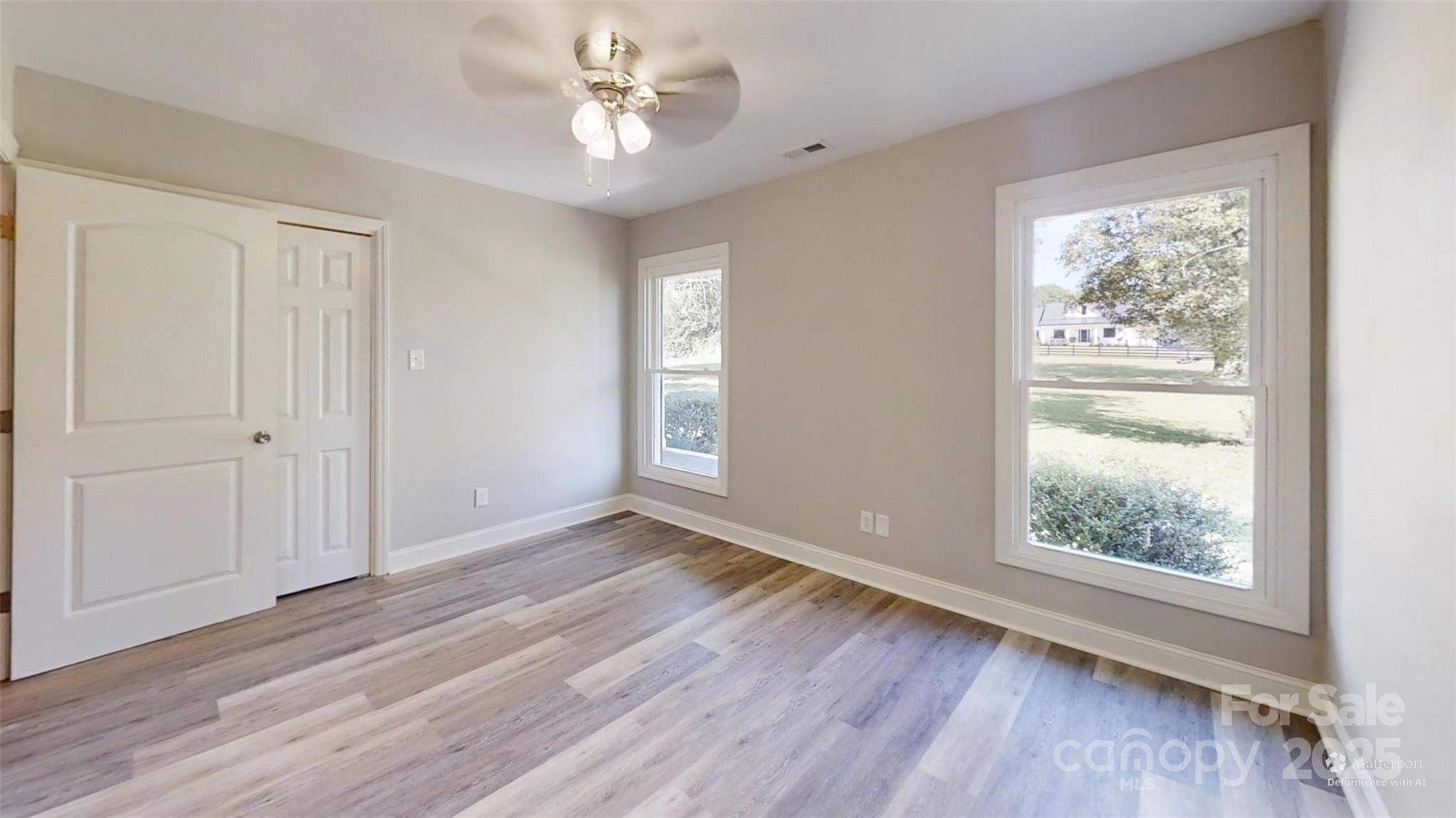 5406 Christopher Road Iron Station, NC 28080 - Photo 12 of 23 a view of an empty room with a window and wooden floor