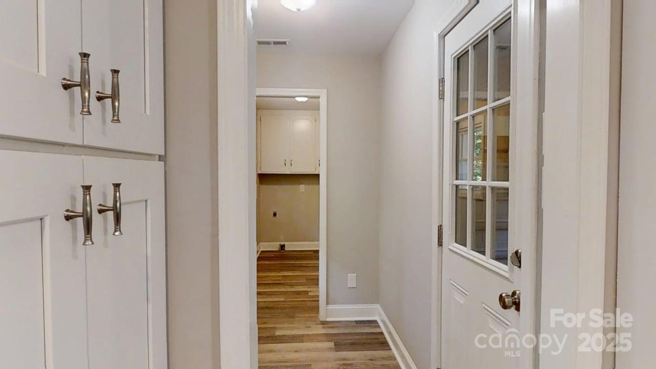 5406 Christopher Road Iron Station, NC 28080 - Photo 18 of 23 a view of a hallway with a door and stairs