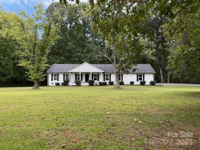 5406 Christopher Road Iron Station, NC 28080 - Photo 20 of 23 a front view of a house with yard and trees
