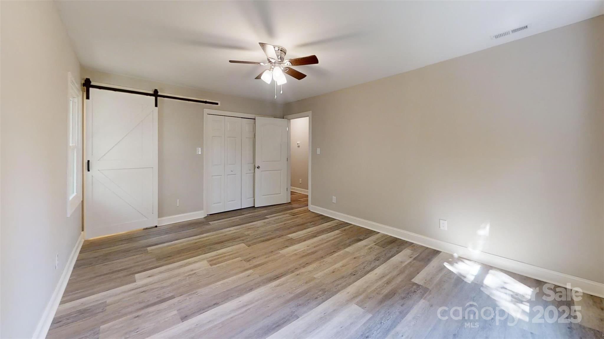 5406 Christopher Road Iron Station, NC 28080 - Photo 10 of 23 a view of empty room with wooden floor