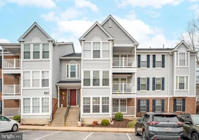a front view of a residential apartment building with a yard