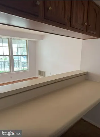 a view of a window and a kitchen with sink