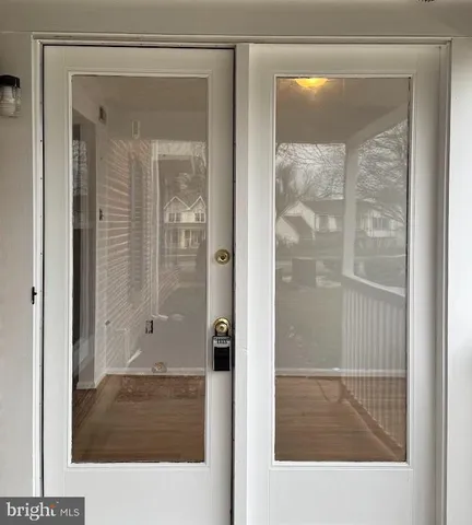 a bathroom with a glass shower door and a glass door
