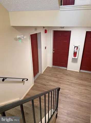 a view of a hallway and wooden floor