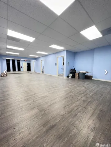 a view of a room with wooden floor