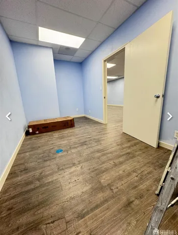 a view of room with wooden floor