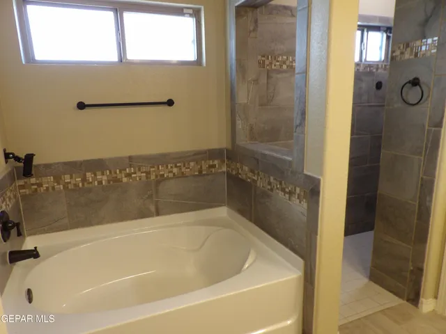a bath tub sitting next to a bathroom sink