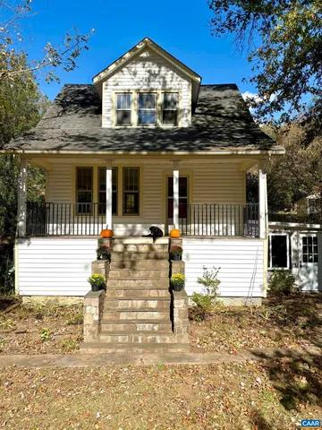 a view of staircase and hall with wooden floor