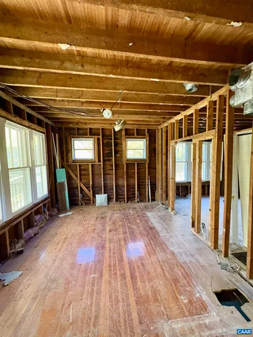 a view of an empty room with a fireplace and a window
