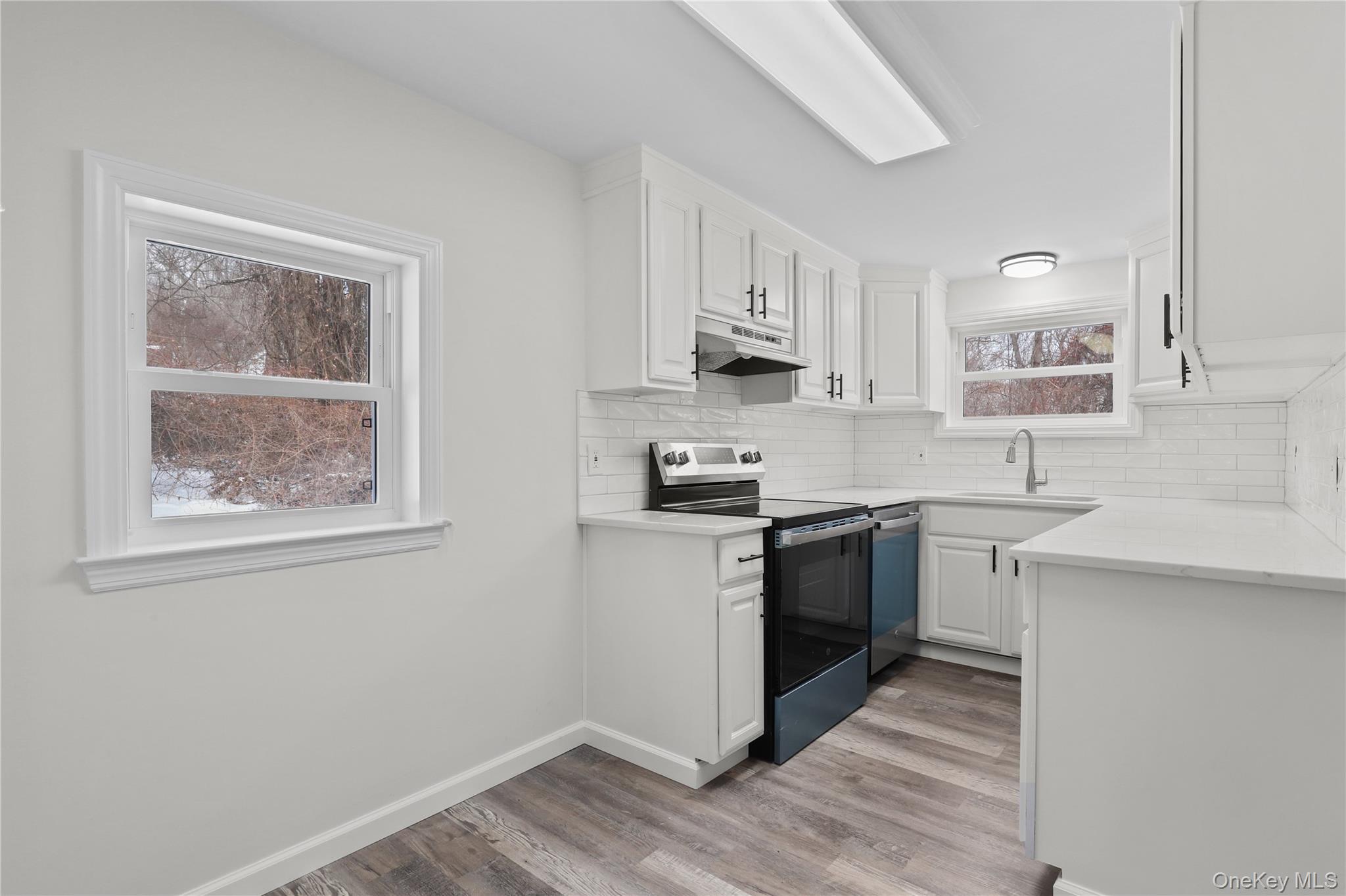 28 Quaker Road Carmel, NY 10512 - Photo 4 of 16 a kitchen with stainless steel appliances granite countertop a sink stove and cabinets