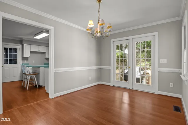 a kitchen with stainless steel appliances granite countertop a sink a stove a table and chairs