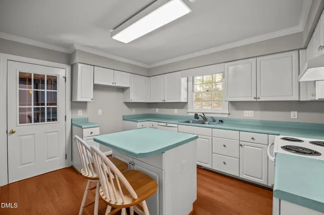 a kitchen with white cabinets and white appliances