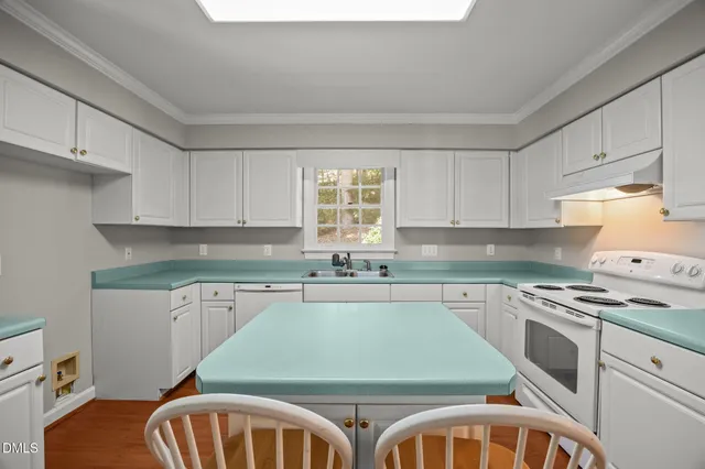 a kitchen with a stove a sink and a refrigerator