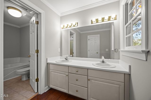 a bathroom with a sink toilet a mirror and shower