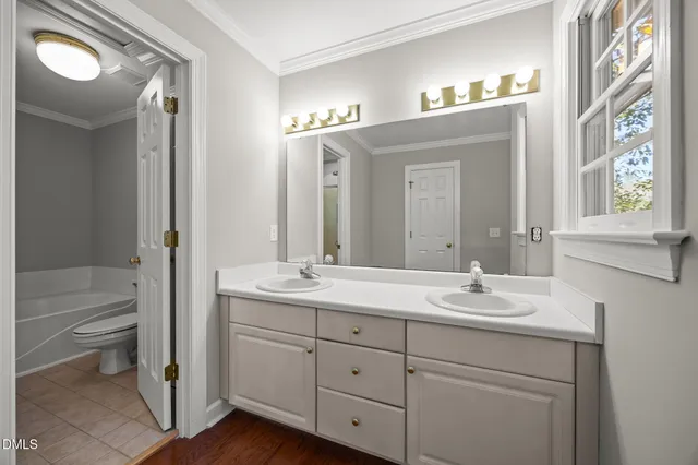 a bathroom with a sink toilet a mirror and shower
