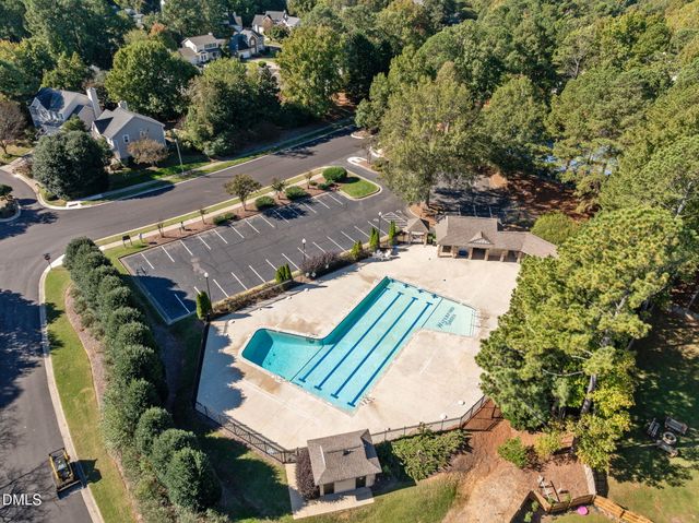 an aerial view of a house with a yard and lake view