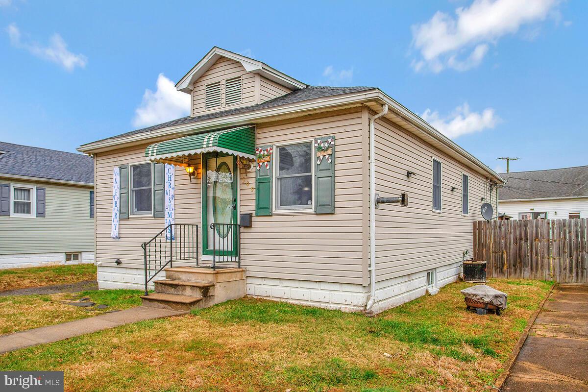 a view of a house with a yard and sitting area