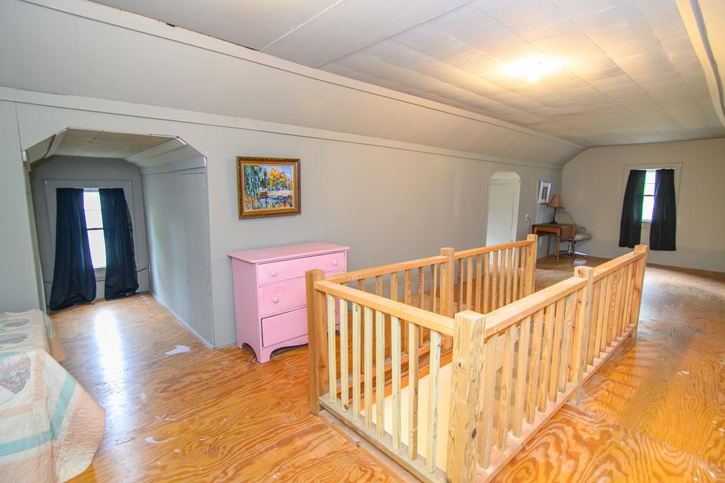 24432 Maxwell Street Parksley, VA 23421 - Photo 26 of 39 a view of a hallway to a livingroom with wooden floor and windows