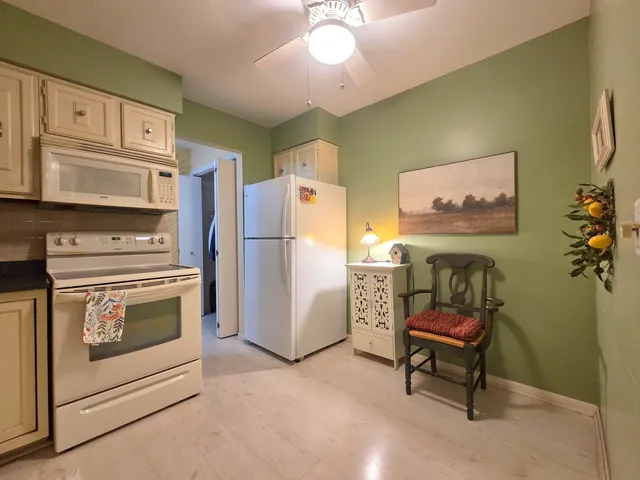 a kitchen with stainless steel appliances a stove a refrigerator and a refrigerator with wooden cabinets