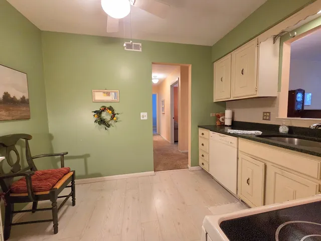 a large white kitchen with cabinets