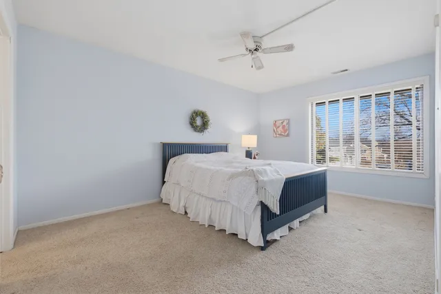 a spacious bedroom with a bed and a window