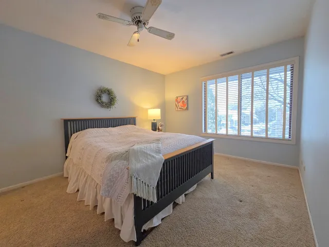 a spacious bedroom with a bed and a window