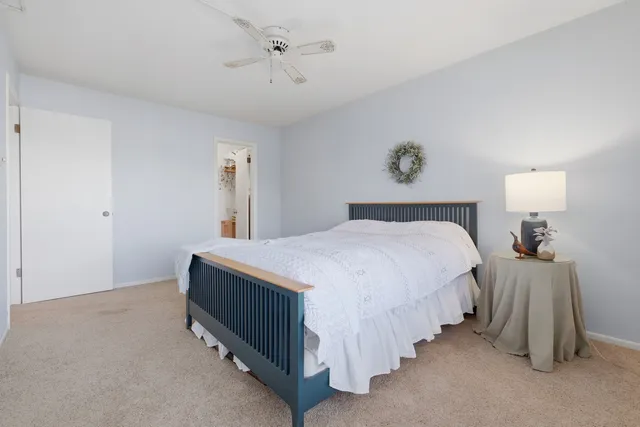 a bed room with a bed and a night stand